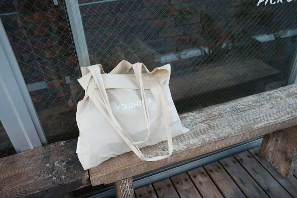 A beige tote bag on a bench