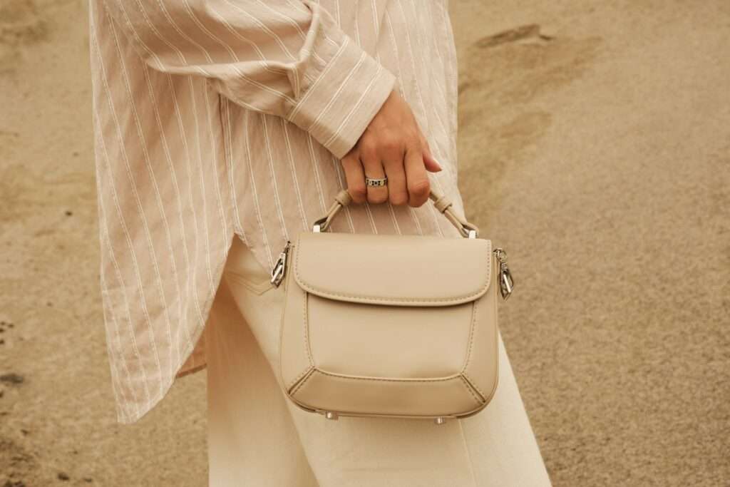 A woman carrying a white purse