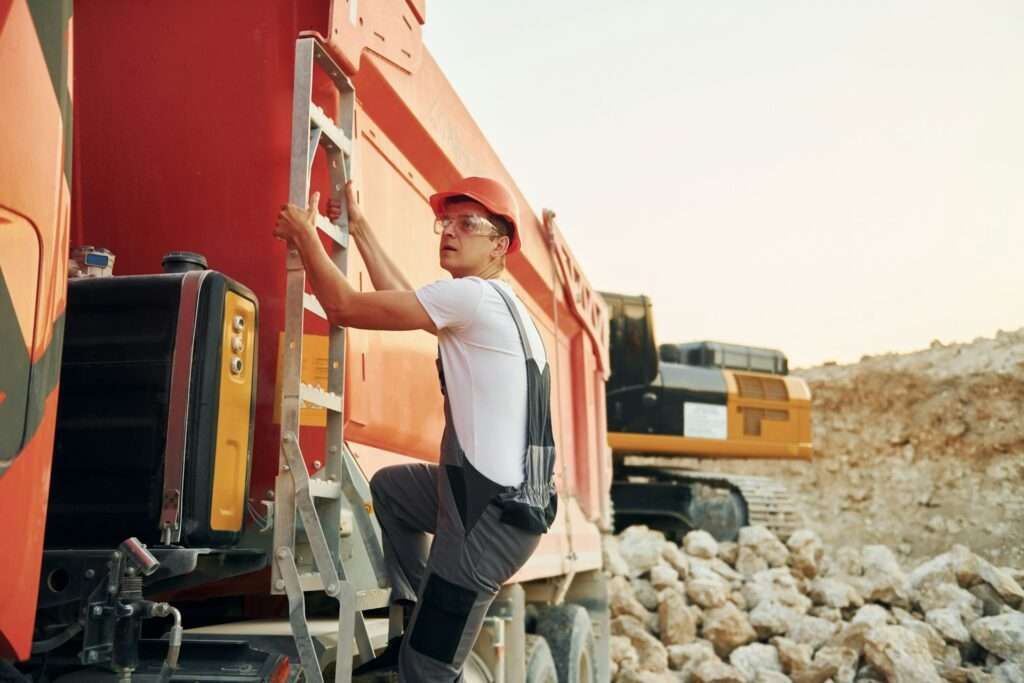 A man climbing up a vehicle