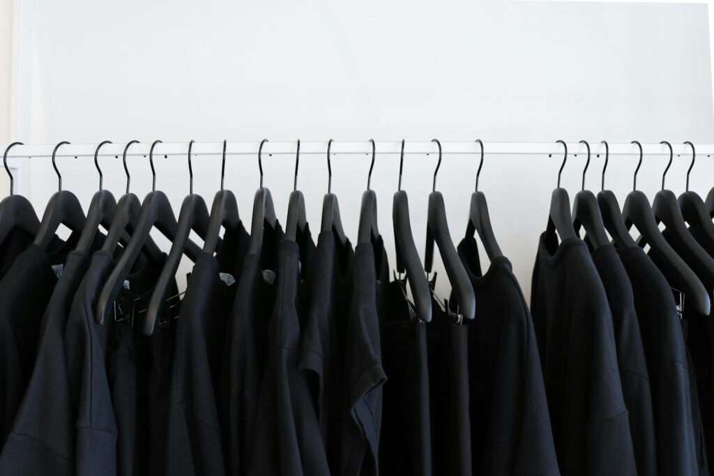 Black clothes hanged in rack