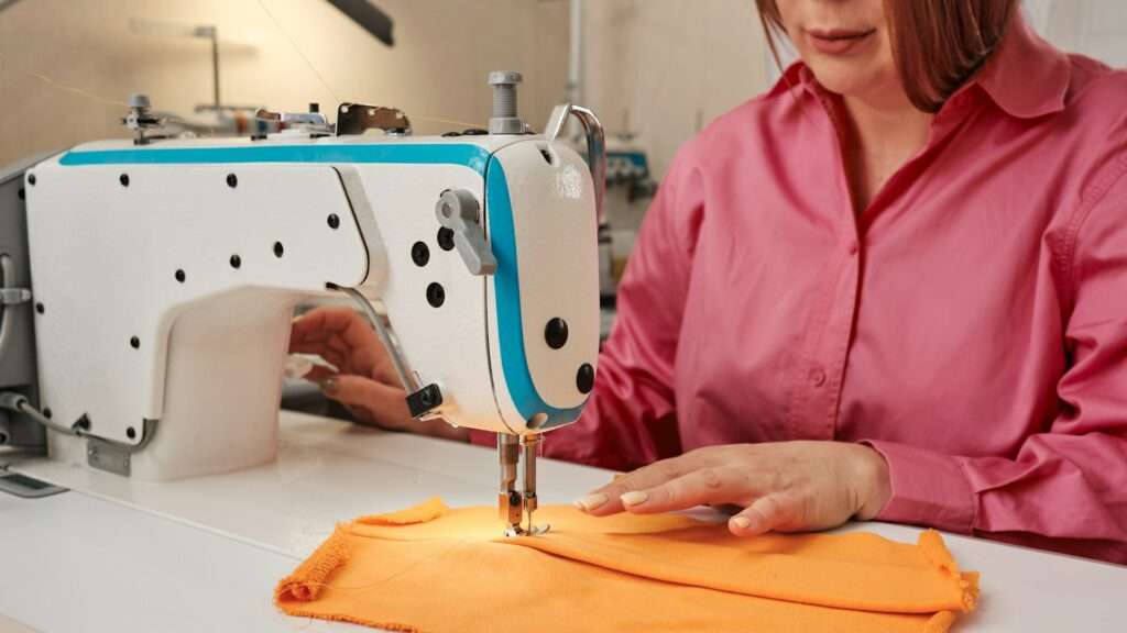 A woman working on a sewing machine image