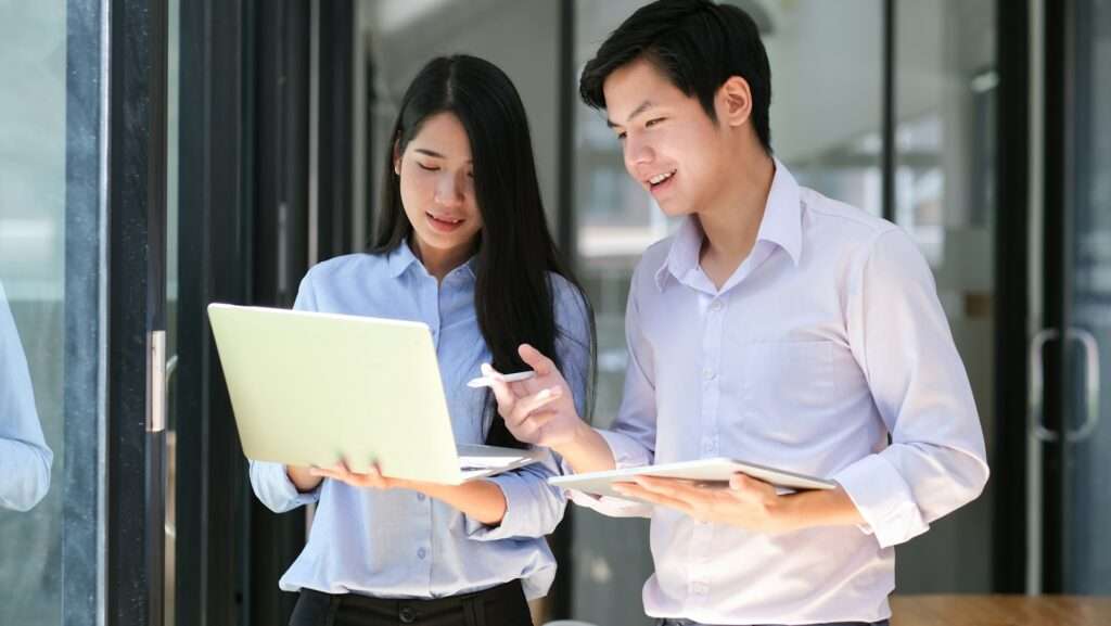 Two person holding a device