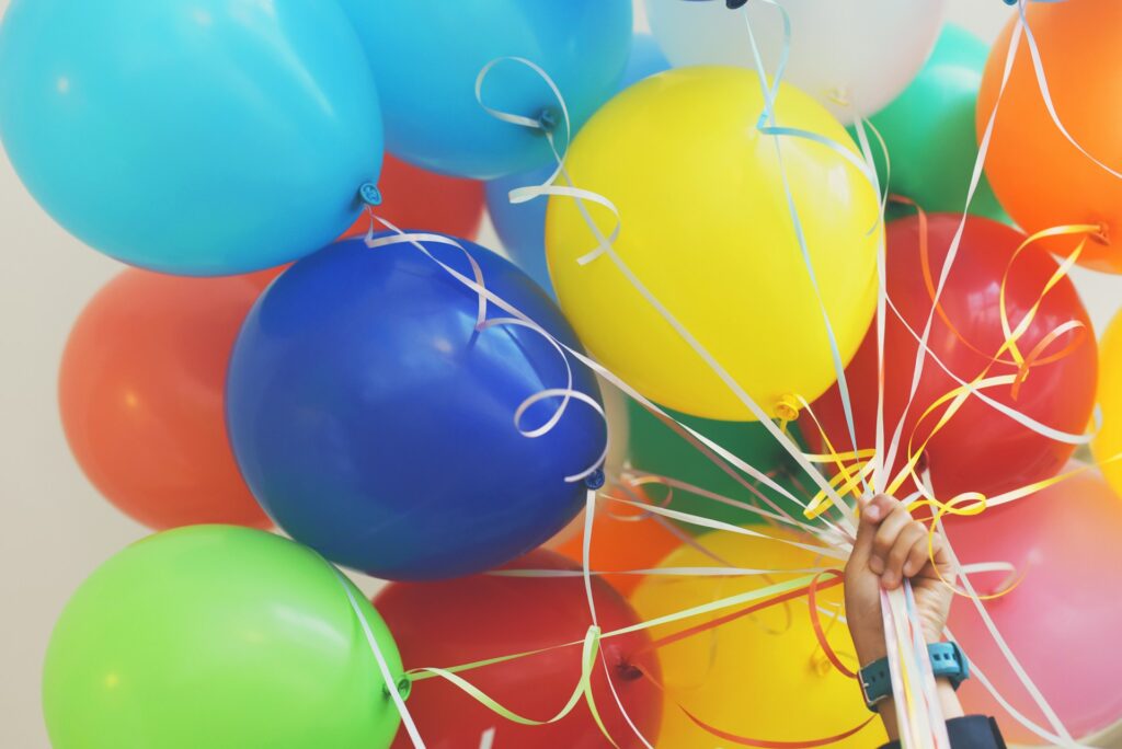 Person holding balloons image