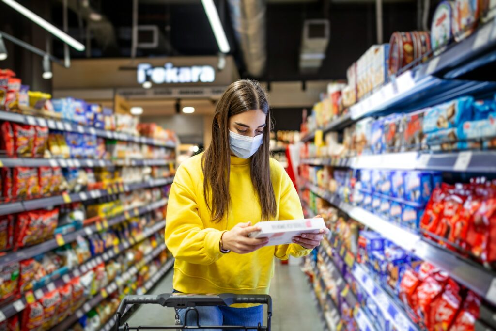 A woman in yellow looking on a paper image