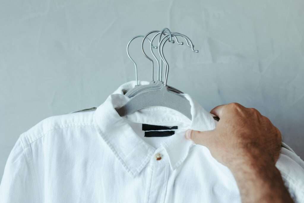 A man holding a white shirt image