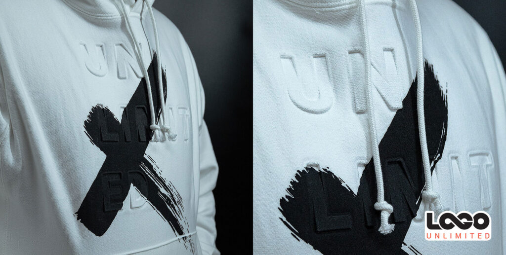 Two hooded sweatshirts side by side, light and dark, featuring a bold black brushstroke X graphic and the LOCO UNLIMITED logo in the bottom right.