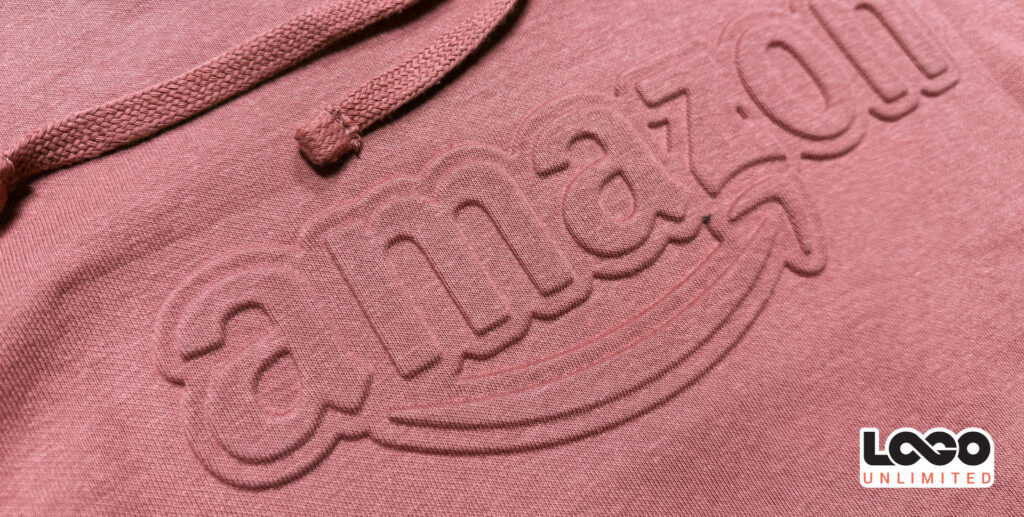 Close-up of pink fabric with embossed 'unlimited' lettering and a small LOCO Unlimited logo in the corner.
