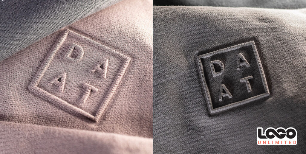 Close-up of two fabric patches on textured material, each square patch spelling D A T; left patch on light pink fabric, right patch on dark gray fabric (split image).