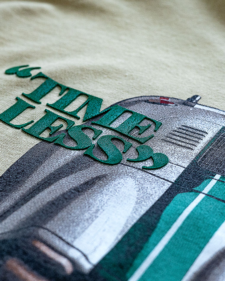 Close-up of teal 3D text reading 'LINDEN PRESS' laid across a grayscale photo of a vehicle and road object.